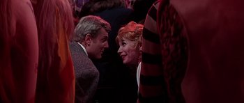 Movie still from “Sweet Charity” (1969), directed by Bob Fosse – A man and a woman talking to each other in a crowd; Close Up shot, Over the shoulder angle