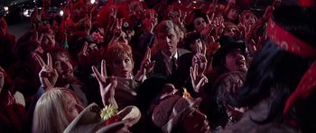 Movie still from “Sweet Charity” (1969), directed by Bob Fosse – A group of people sitting in a room with their hands up; Medium shot, High angle