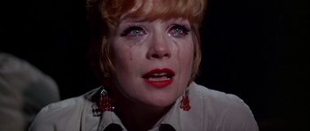 Movie still from “Sweet Charity” (1969), directed by Bob Fosse – A person crying with red lipstick; Close Up shot, High angle