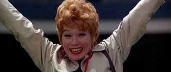 Movie still from “Sweet Charity” (1969), directed by Bob Fosse – An older woman with red hair and a smile; Close Up shot, Low angle