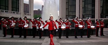 Movie still from “Sweet Charity” (1969), directed by Bob Fosse – A group of men in red and black uniforms; Wide shot, Low angle