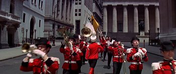 Movie still from “Sweet Charity” (1969), directed by Bob Fosse – A group of people marching down a street; Extreme Wide shot, Low angle