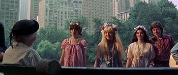 Movie still from “Sweet Charity” (1969), directed by Bob Fosse – Two young women wearing flower wreaths in front of a city skyline; Medium shot, High angle