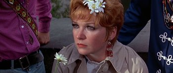 Movie still from “Sweet Charity” (1969), directed by Bob Fosse – A person with a flower in her hair; Close Up shot, Over the shoulder angle