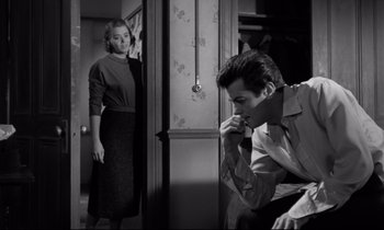 Movie still from “Sweet Smell of Success” (1957), directed by Alexander Mackendrick – A man and a woman are standing in a room; Medium shot, Over the shoulder angle
