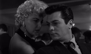 Movie still from “Sweet Smell of Success” (1957), directed by Alexander Mackendrick – A man and a woman are looking at one another; Close Up shot, Low angle
