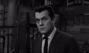 Movie still from “Sweet Smell of Success” (1957), directed by Alexander Mackendrick – Black and white photograph of a man wearing a suit and tie; Close Up shot, Low angle