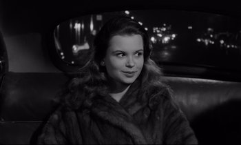 Movie still from “Sweet Smell of Success” (1957), directed by Alexander Mackendrick – A black and white photo of a woman sitting in a car; Close Up shot, High angle