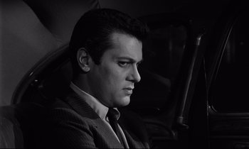 Movie still from “Sweet Smell of Success” (1957), directed by Alexander Mackendrick – Black and white photograph of a man sitting in a car; Close Up shot, Low angle