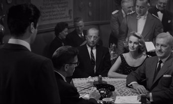 Movie still from “Sweet Smell of Success” (1957), directed by Alexander Mackendrick – A black and white photo of people sitting at a table; Medium shot, Over the shoulder angle
