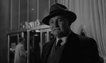 Movie still from “Sweet Smell of Success” (1957), directed by Alexander Mackendrick – An older man wearing a suit and a hat; Close Up shot, Low angle