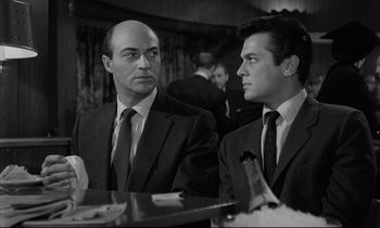 Movie still from “Sweet Smell of Success” (1957), directed by Alexander Mackendrick – A black and white photo of two men in suits; Close Up shot, Low angle