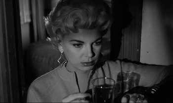 Movie still from “Sweet Smell of Success” (1957), directed by Alexander Mackendrick – A black and white photo of a woman holding a glass of wine; Close Up shot, Low angle
