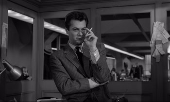 Movie still from “Sweet Smell of Success” (1957), directed by Alexander Mackendrick – A black and white photo of a man smoking a cigarette; Close Up shot, Low angle