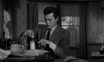 Movie still from “Sweet Smell of Success” (1957), directed by Alexander Mackendrick – A black and white photo of a man in a suit and tie; Medium shot, Low angle