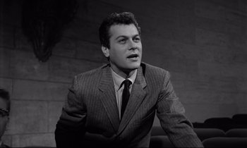 Movie still from “Sweet Smell of Success” (1957), directed by Alexander Mackendrick – Black and white photograph of a man wearing a suit; Close Up shot, Low angle