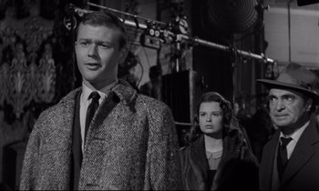 Movie still from “Sweet Smell of Success” (1957), directed by Alexander Mackendrick – A black and white photo of a man and a woman; Medium shot, Low angle