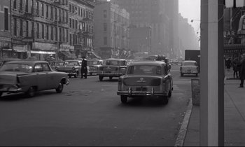 Movie still from “Sweet Smell of Success” (1957), directed by Alexander Mackendrick – A black and white photo of a busy city street; Wide shot, High angle