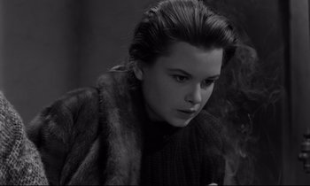 Movie still from “Sweet Smell of Success” (1957), directed by Alexander Mackendrick – A black - and - white photo of a woman in a fur coat; Close Up shot, High angle