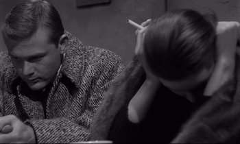 Movie still from “Sweet Smell of Success” (1957), directed by Alexander Mackendrick – Two people sitting on a couch with one smoking a cigarette; Close Up shot, High angle