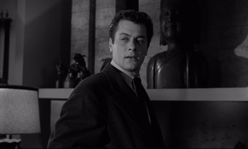 Movie still from “Sweet Smell of Success” (1957), directed by Alexander Mackendrick – Black and white photograph of a man wearing a suit and tie; Close Up shot, Low angle