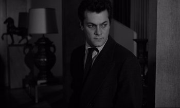 Movie still from “Sweet Smell of Success” (1957), directed by Alexander Mackendrick – Black and white photograph of a man in a suit; Close Up shot, Low angle