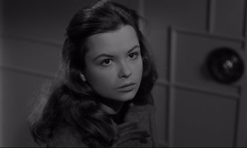 Movie still from “Sweet Smell of Success” (1957), directed by Alexander Mackendrick – A young woman with long hair looking at the camera; Close Up shot, High angle
