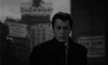 Movie still from “Sweet Smell of Success” (1957), directed by Alexander Mackendrick – A black and white photo of a man in a suit and tie; Close Up shot, Low angle