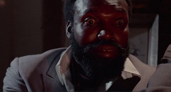 Movie still from “Sweet Sweetback's Baadasssss Song” (1971), directed by Melvin Van Peebles – A person with a beard; Close Up shot, Low angle