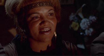 Movie still from “Sweet Sweetback's Baadasssss Song” (1971), directed by Melvin Van Peebles – A person wearing a headdress; Close Up shot, Low angle