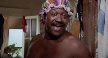 Movie still from “Sweet Sweetback's Baadasssss Song” (1971), directed by Melvin Van Peebles – A man wearing a shower cap in a bathroom; Close Up shot, Low angle