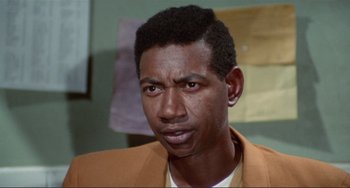 Movie still from “Sweet Sweetback's Baadasssss Song” (1971), directed by Melvin Van Peebles – A person wearing a jacket; Close Up shot, Low angle