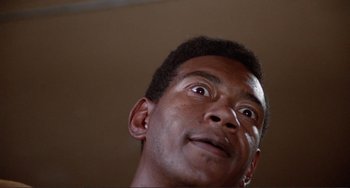 Movie still from “Sweet Sweetback's Baadasssss Song” (1971), directed by Melvin Van Peebles – A person looking up at the sky; Extreme Close Up shot, Low angle