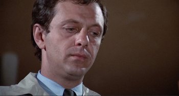 Movie still from “Sweet Sweetback's Baadasssss Song” (1971), directed by Melvin Van Peebles – A person wearing a suit and tie; Close Up shot, Low angle