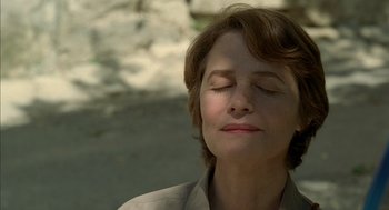 Movie still from “Swimming Pool” (2003), directed by François Ozon – A person with her eyes closed; Close Up shot, Low angle