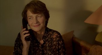 Movie still from “Swimming Pool” (2003), directed by François Ozon – A woman holding a phone up to her ear; Close Up shot, Over the shoulder angle