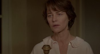 Movie still from “Swimming Pool” (2003), directed by François Ozon – A person holding a candle holder; Close Up shot, Over the shoulder angle