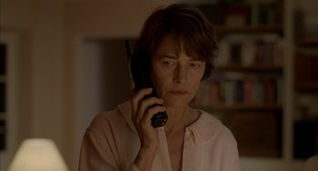 Movie still from “Swimming Pool” (2003), directed by François Ozon – A woman holding a cell phone up to her ear; Close Up shot, Low angle