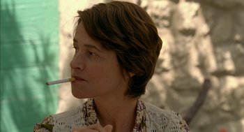 Movie still from “Swimming Pool” (2003), directed by François Ozon – A person with a cigarette in her mouth; Close Up shot, Over the shoulder angle