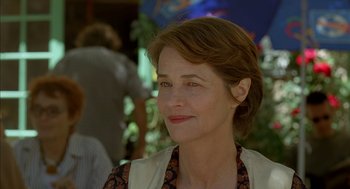 Movie still from “Swimming Pool” (2003), directed by François Ozon – A person wearing a jacket; Close Up shot, Over the shoulder angle