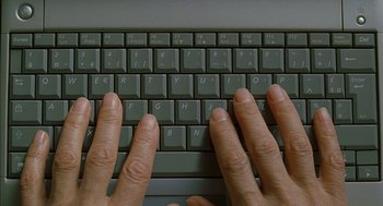 Movie still from “Swimming Pool” (2003), directed by François Ozon – A person is typing on a computer keyboard; Extreme Close Up shot, Overhead angle