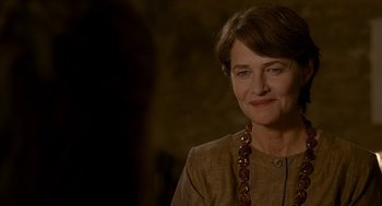 Movie still from “Swimming Pool” (2003), directed by François Ozon – An older woman wearing a brown jacket and a brown necklace; Close Up shot, Over the shoulder angle