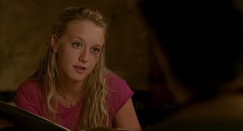 Movie still from “Swimming Pool” (2003), directed by François Ozon – A woman sitting in front of an open book; Close Up shot, Over the shoulder angle
