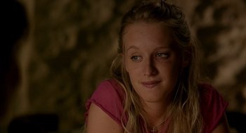 Movie still from “Swimming Pool” (2003), directed by François Ozon – A young woman with long blonde hair wearing a pink shirt; Close Up shot, Over the shoulder angle
