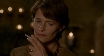 Movie still from “Swimming Pool” (2003), directed by François Ozon – A person smoking a cigarette; Close Up shot, Over the shoulder angle