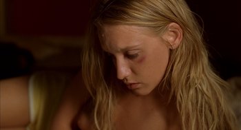 Movie still from “Swimming Pool” (2003), directed by François Ozon – A young woman with a bruised eye and a bruised face; Close Up shot, High angle