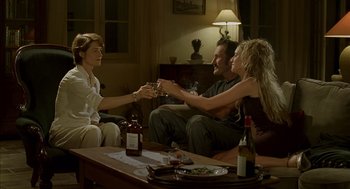 Movie still from “Swimming Pool” (2003), directed by François Ozon – A group of people sitting around a living room; Wide shot, High angle