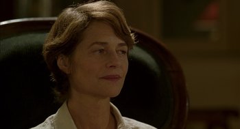 Movie still from “Swimming Pool” (2003), directed by François Ozon – A person wearing a white shirt; Close Up shot, Over the shoulder angle