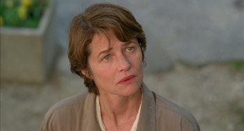Movie still from “Swimming Pool” (2003), directed by François Ozon – A person with short brown hair; Close Up shot, Low angle