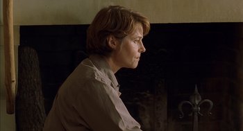 Movie still from “Swimming Pool” (2003), directed by François Ozon – A woman with short brown hair wearing a brown shirt; Close Up shot, Over the shoulder angle